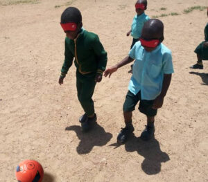Children Playing Blind Football with Apricot
